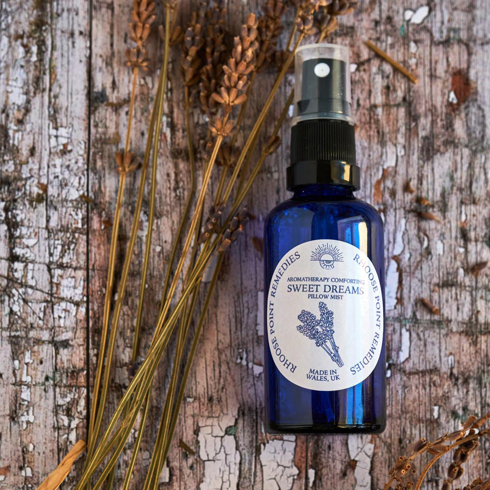 Lavender Pillow Spray next to lavender flowers