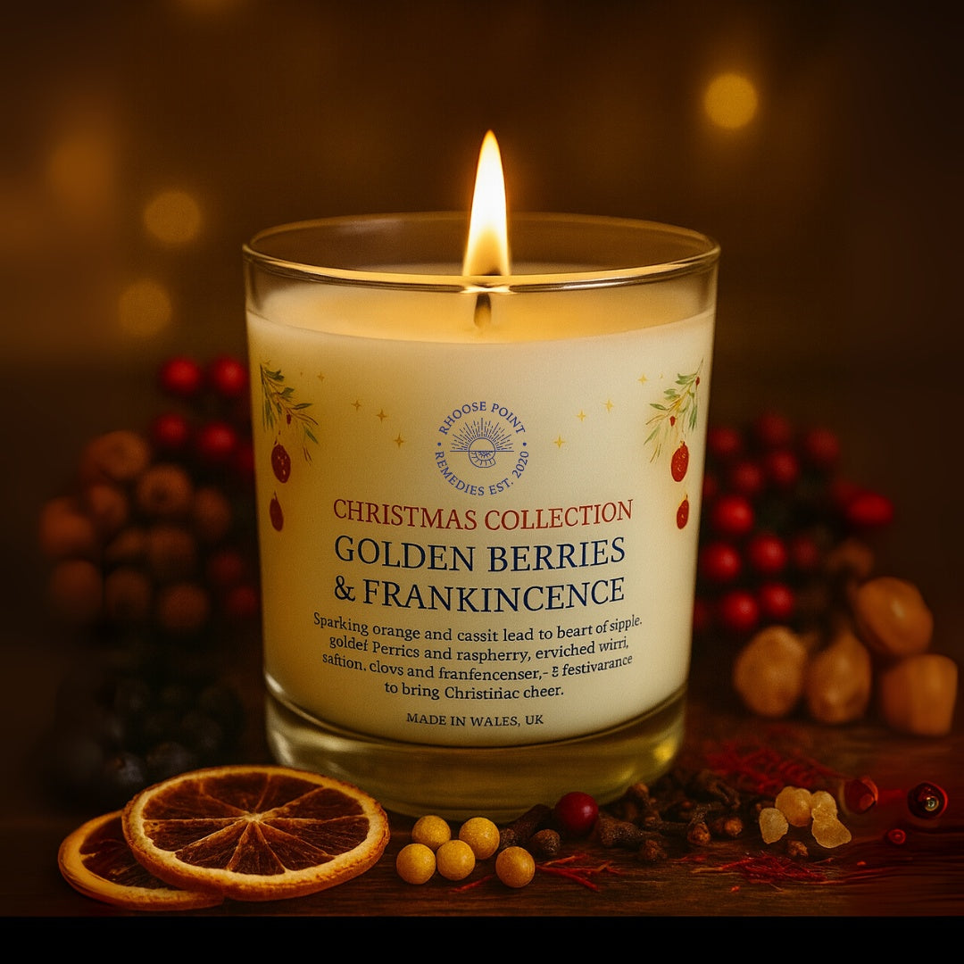 Candle labeled 'Golden Berries & Frankincense' from the Christmas Collection on a wooden surface with decorative elements.