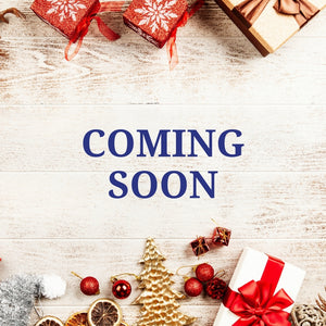 Decorative setup with Christmas elements and 'COMING SOON' text on a wooden surface.