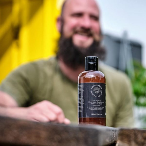 Man smiling with 3-in-1 Natural Beard Shampoo