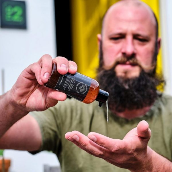 Man pouring some 3-in-1 Natural Beard Shampoo
