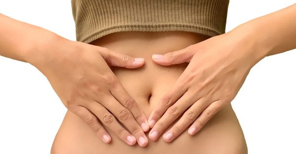 Massage oil for period pain Woman touching her belly